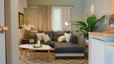 a living room with a couch and a table at The Clay Nest in Athens