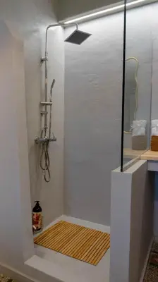 a shower with a glass door in a bathroom at The Clay Nest in Athens