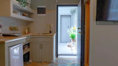 a kitchen with a sink and a door to a hallway at The Clay Nest in Athens