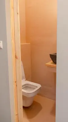a bathroom with a white toilet in a room at The Clay Nest in Athens