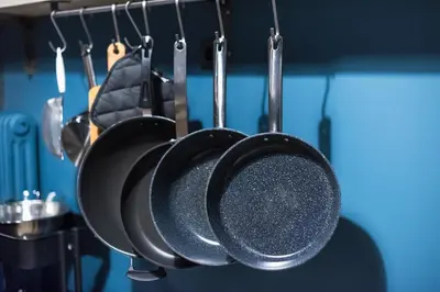 a bunch of pots and pans hanging in a kitchen at Athen's cozy home in Athens
