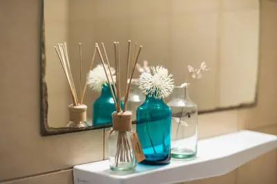 three vases sitting on a counter in front of a mirror at Athen's cozy home in Athens