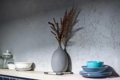 a vase with a plant in it sitting on a shelf at Athen's cozy home in Athens