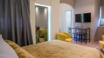a hotel room with a bed and a table and chairs at Cozy Roots in Athens