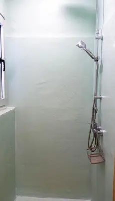a shower in a bathroom with a glass door at Cozy Roots in Athens
