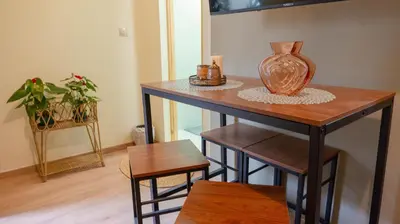 a table with a vase sitting on top of it at Cozy Roots in Athens