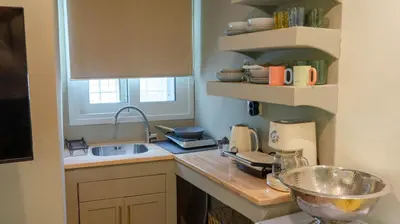 a kitchen with a counter top with a sink and a counter top at Cozy Roots in Athens