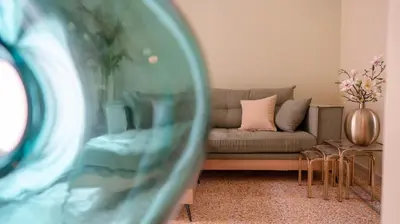 a living room with a couch with a pink pillow at The Garden Loft in Athens