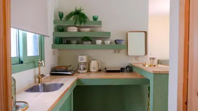 a kitchen with a sink and a mirror at The Garden Loft in Athens