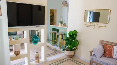 a living room with a flat screen tv on a wall at The Garden Loft in Athens