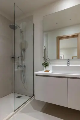 a bathroom with a sink and a shower and a mirror at Gallery Port Tower Piraeus in Piraeus