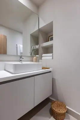 a white bathroom with a sink and a mirror at Gallery Port Tower Piraeus in Piraeus
