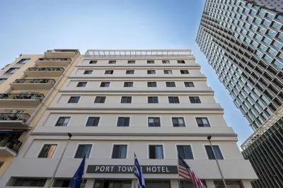a tall white building with a port town hotel at Gallery Port Tower Piraeus in Piraeus