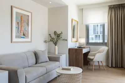 a living room with a couch and a table at Gallery Port Tower Piraeus in Piraeus