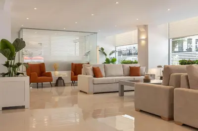 a living room with couches and chairs at Gallery Port Tower Piraeus in Piraeus