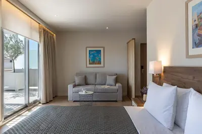 a hotel room with a bed and a couch at Gallery Port Tower Piraeus in Piraeus