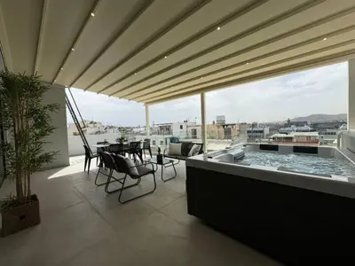 a balcony with a pool and a table and chairs at BlueMotion - Cruisenest Transportation included in Piraeus