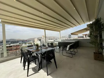 a patio with a table and chairs on a balcony at BlueMotion - Cruisenest Transportation included in Piraeus