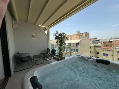 a bath tub in a room with a view of a city at BlueMotion - Cruisenest Transportation included in Piraeus