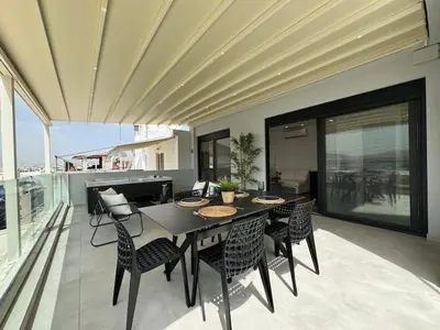 a dining room with a black table and chairs at BlueMotion - Cruisenest Transportation included in Piraeus
