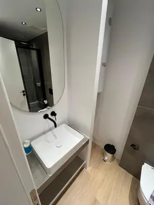 a bathroom with a sink and a mirror at BlueMotion - Cruisenest Transportation included in Piraeus