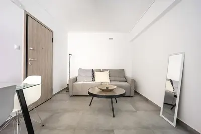 a living room with a couch and a table at Varkizaki by the sea in Varkiza