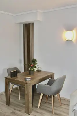 a dining room with a wooden table and two chairs at Beachside Retreat in Glyfada in Athens