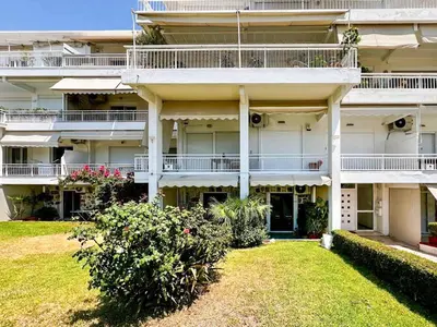 a large apartment building with balconies and a yard at Beachside Retreat in Glyfada in Athens