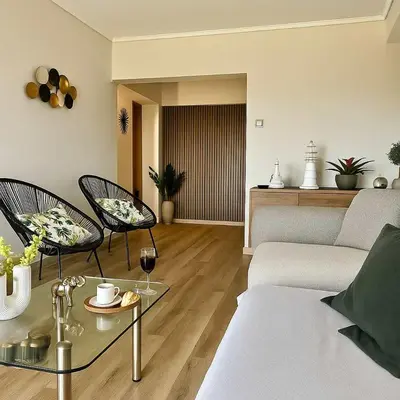 a living room with a couch and two chairs at Beachside Retreat in Glyfada in Athens