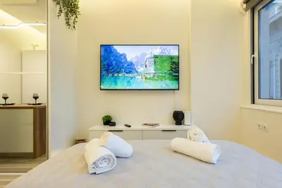 a bedroom with a bed with two white towels at Little Paradise in Athens with a Church View in Athens