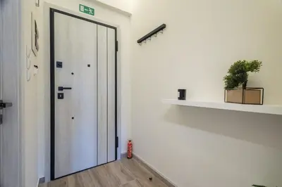 a hallway with a door and a shelf with a plant at Little Paradise in Athens with a Church View in Athens