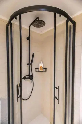 a shower with a glass door in a bathroom at Little Paradise in Athens with a Church View in Athens