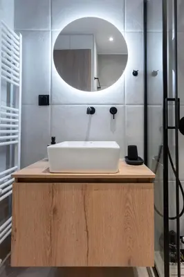 a bathroom with a white sink and a mirror at Stylish 2BR flat near hospital & Panormou metro in Athens