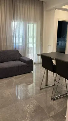 a living room with a couch and a table at Agios Nikolaos apartment in Athens