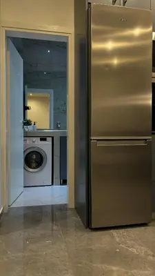 a kitchen with a refrigerator and a washing machine at Agios Nikolaos apartment in Athens