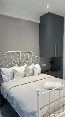 a bedroom with a large white bed with white pillows at Agios Nikolaos apartment in Athens
