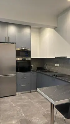 a kitchen with stainless steel appliances and a table at Agios Nikolaos apartment in Athens