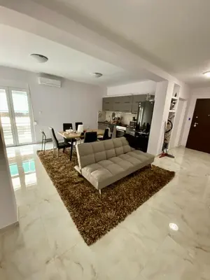 a white living room with a couch and a table at studio room with private bathroom-floor 2 in Athens