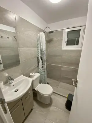 a bathroom with a white toilet and a sink at studio room with private bathroom-floor 2 in Athens