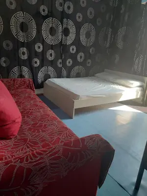 a bedroom with a white bed and a wall with at SHARING ROOM IN NEAR THISSIO METRO STATION BY ACROPOLIs in Athens