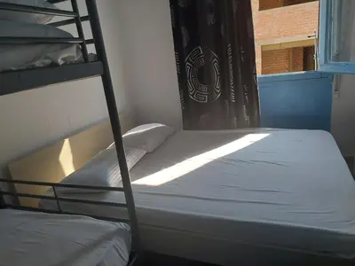 a bedroom with two bunk beds and a window at SHARING ROOM IN NEAR THISSIO METRO STATION BY ACROPOLIs in Athens