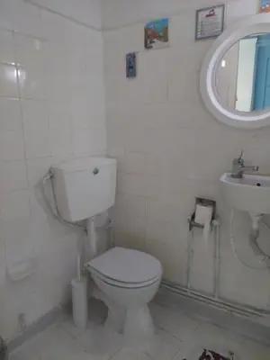 a white bathroom with a toilet and a sink at SHARING ROOM IN NEAR THISSIO METRO STATION BY ACROPOLIs in Athens