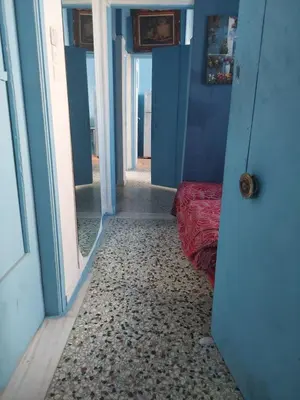 a room with blue walls and a door with a bed at SHARING ROOM IN NEAR THISSIO METRO STATION BY ACROPOLIs in Athens