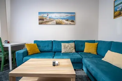 a blue couch in a living room with a coffee table at Athens Vibe Apartment - Gazi by ΜΡS in Athens