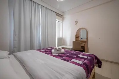 a bedroom with a bed and a desk and a mirror at Athens Vibe Apartment - Gazi by ΜΡS in Athens