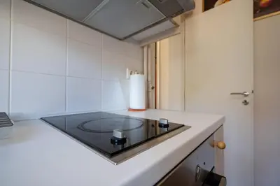 a kitchen with a counter with a glass counter top at Athens Vibe Apartment - Gazi by ΜΡS in Athens