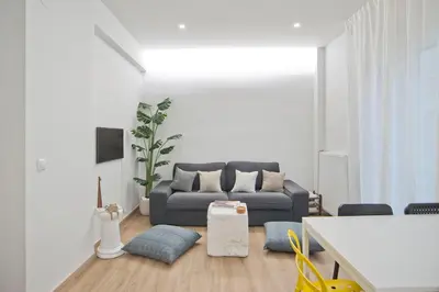 a living room with a couch and a table at Aether Athens Luxurious Fully Renovated Apt in Athens
