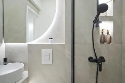 a bathroom with a shower and a white sink at Aether Athens Luxurious Fully Renovated Apt in Athens