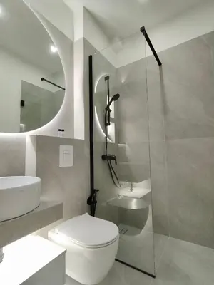 a bathroom with a toilet and a sink and a shower at Aether Athens Luxurious Fully Renovated Apt in Athens