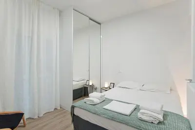 a white bedroom with a bed and a mirror at Aether Athens Luxurious Fully Renovated Apt in Athens